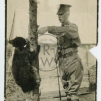 Harry Colebourn with Winnie climbing a tree
